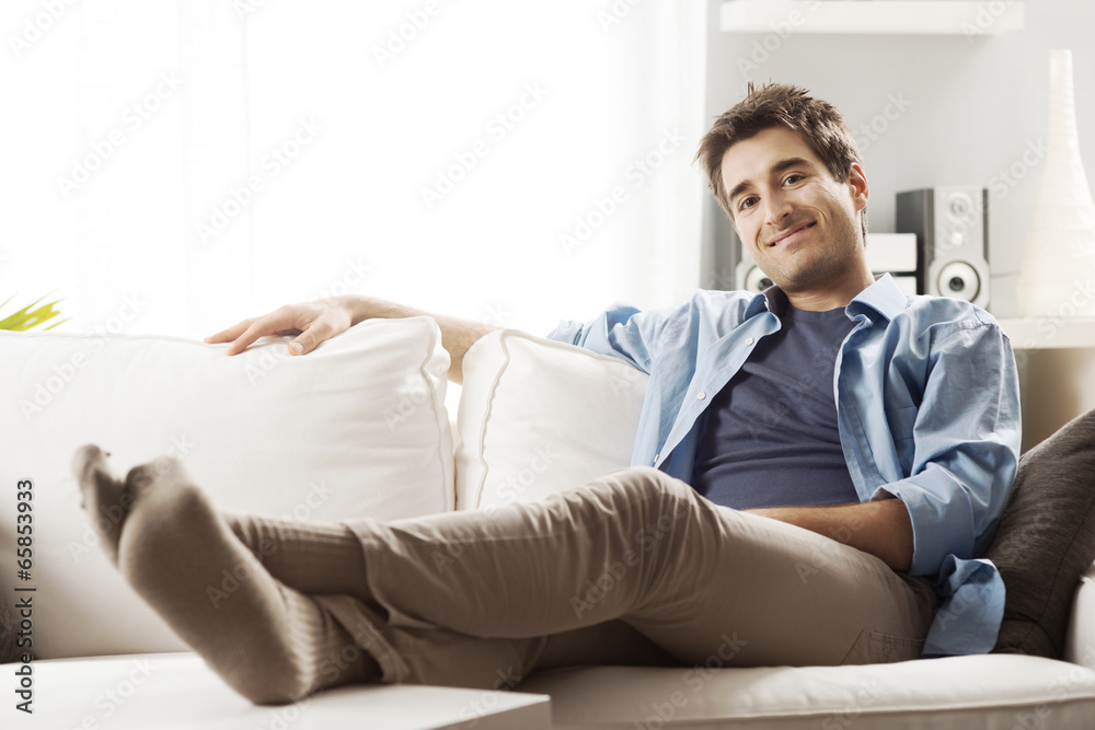 Young man relaxing on sofa
