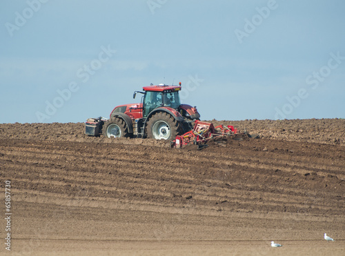 Wallpaper Mural Tractor ploughing agricultural land