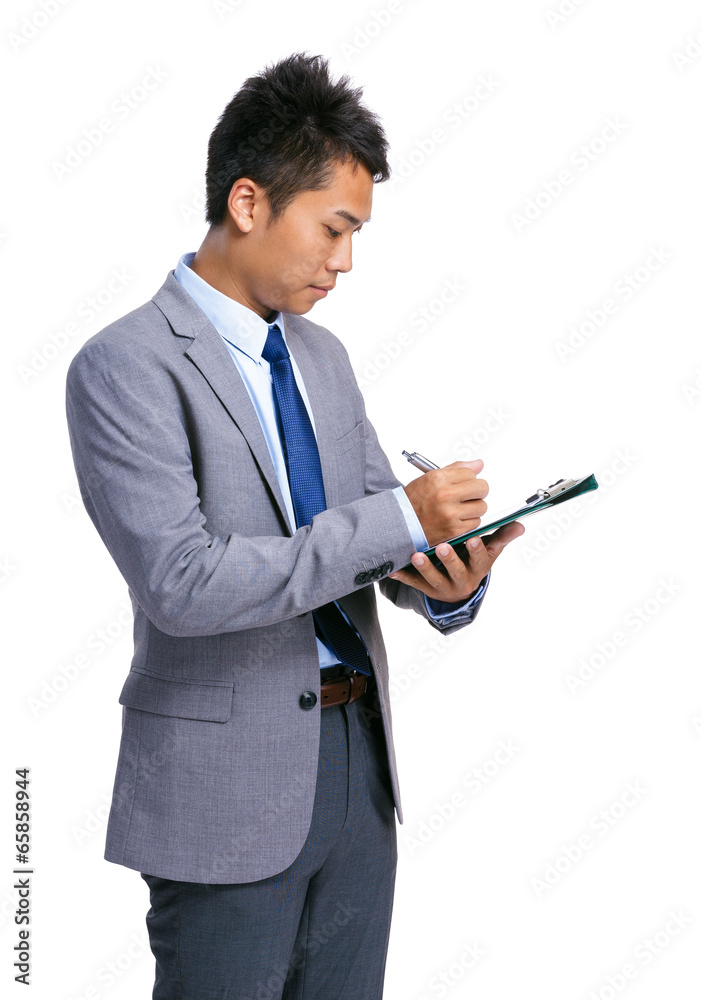 Businessman write on clipboard Businessman write on clipboard