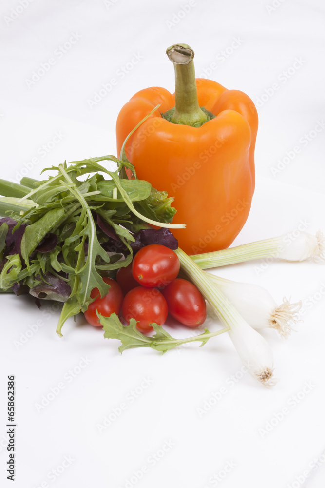 Salad, tomatoes, spring onions and orange pepper isolated on whi Salad, tomatoes, spring onions and orange pepper isolated on whi