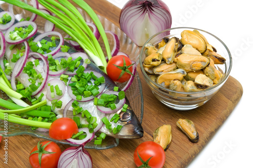 salted herring, mussels and vegetables closeup. white background