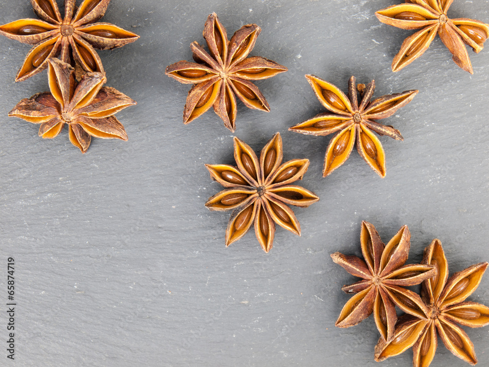 close up of star anise on black slate close up of star anise on black slate