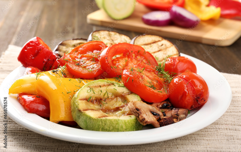 Delicious grilled vegetables on plate on table close-up Delicious grilled vegetables on plate on table close-up