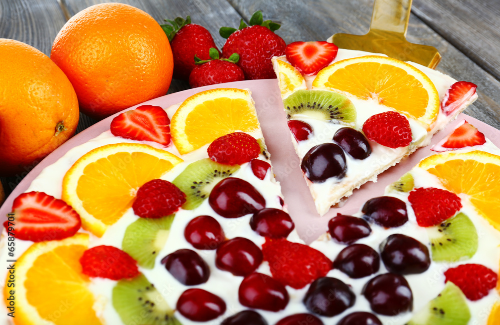 Homemade sweet pizza with fruits on wooden table, close up Homemade sweet pizza with fruits on wooden table, close up