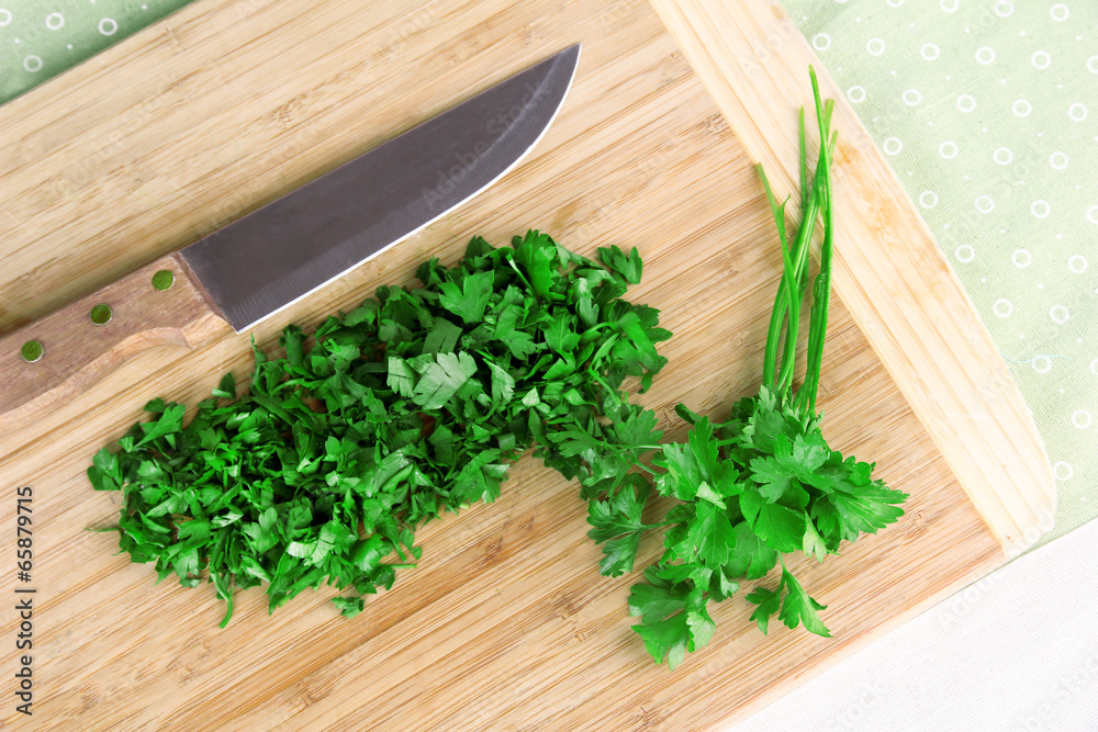 Chopped greens with knife on cutting board Chopped greens with knife on cutting board