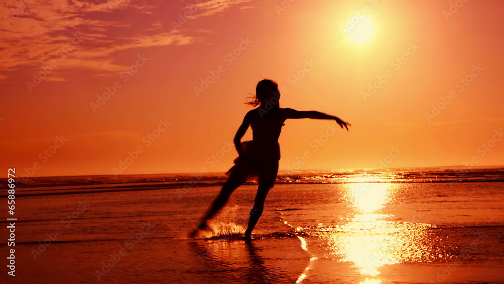SIlhouette of girl dancing on Beach at sunset SIlhouette of girl dancing on Beach at sunset