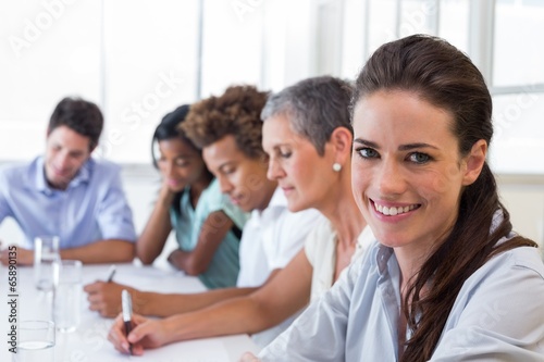 Businesswoman smiling at business meeting