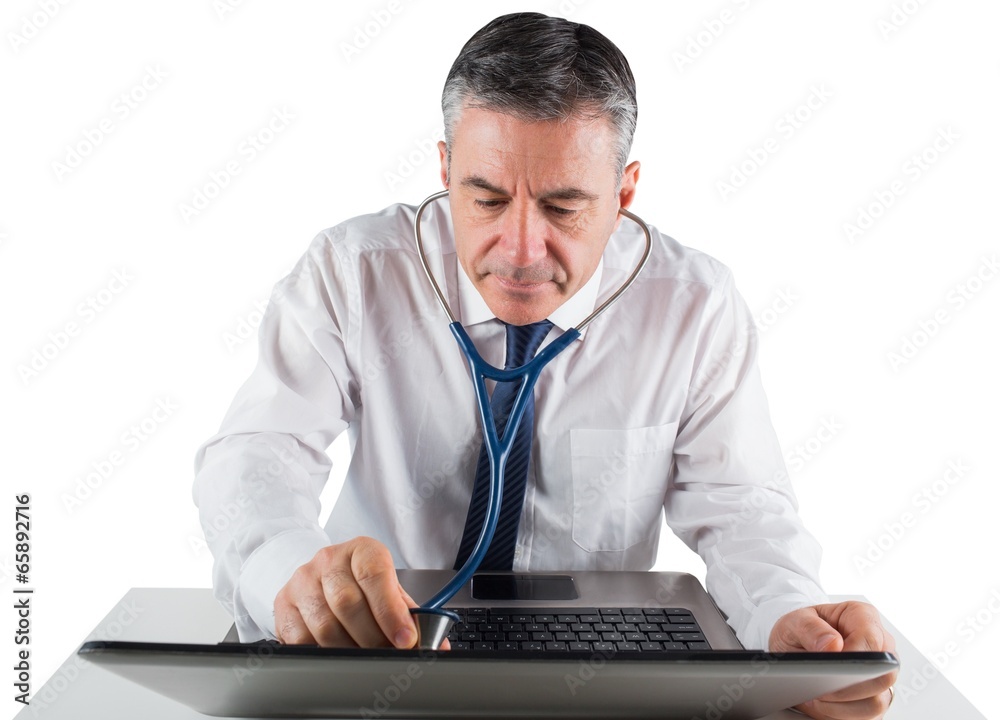 Mature businessman running diagnostics on laptop Mature businessman running diagnostics on laptop