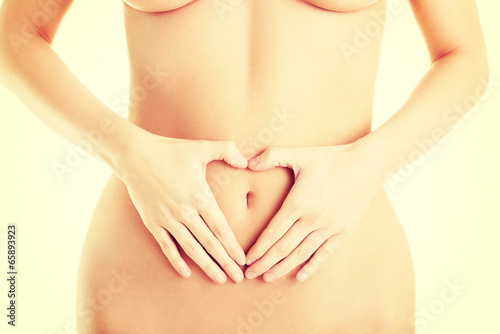 Wallpaper Mural Attractive woman making heart shape on belly Torontodigital.ca