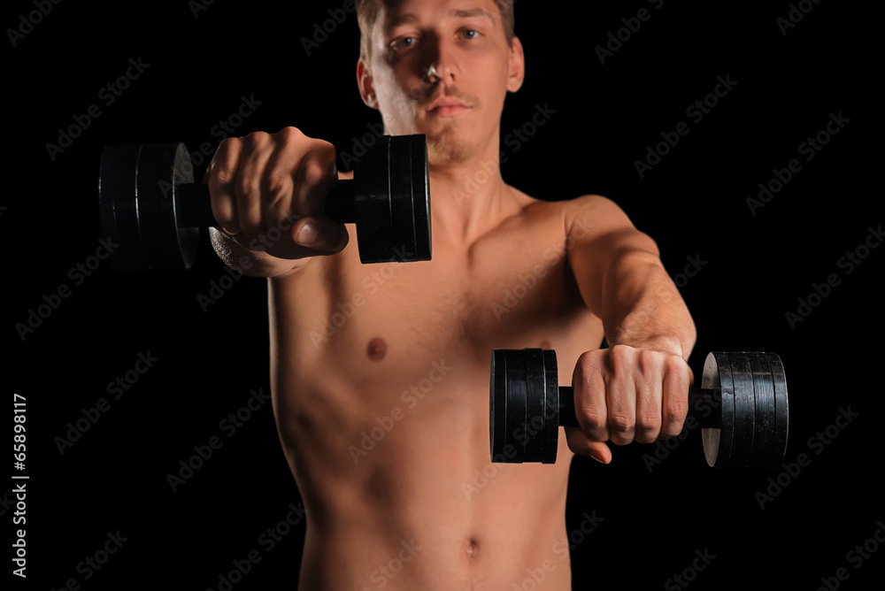Man exercises with dumbbells
