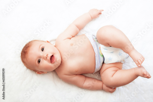Smiling Baby Girl are Lying in the Bed