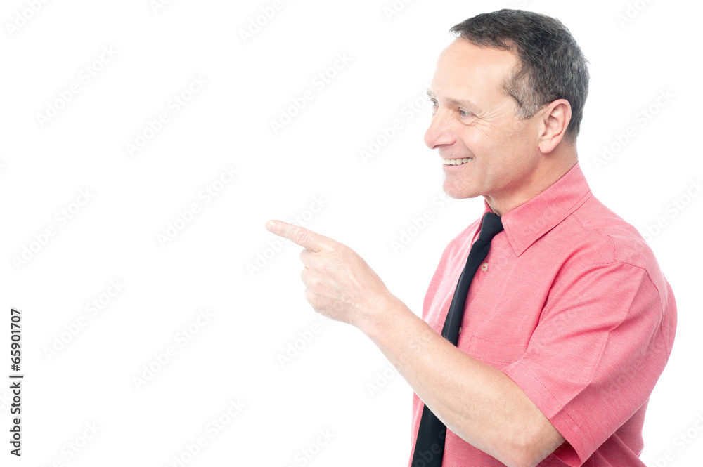 Smiling man pointing his finger towards something Smiling man pointing his finger towards something