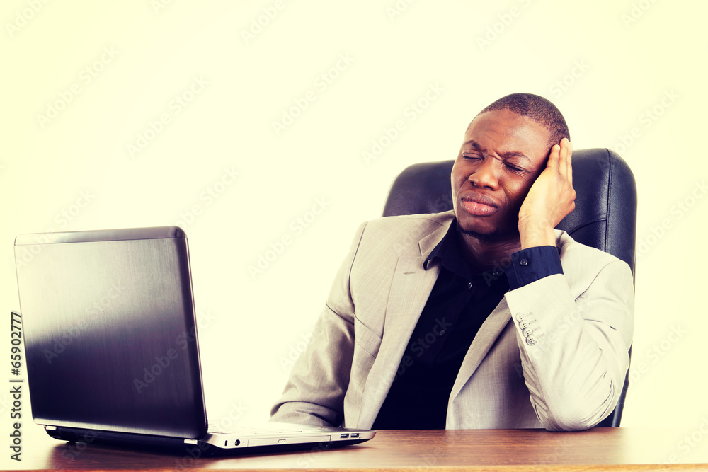 Stressed businessman working on laptop Stressed businessman working on laptop