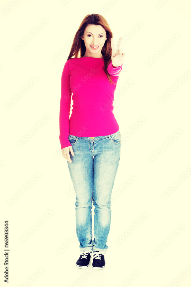 Happy woman showing victory sign Happy woman showing victory sign