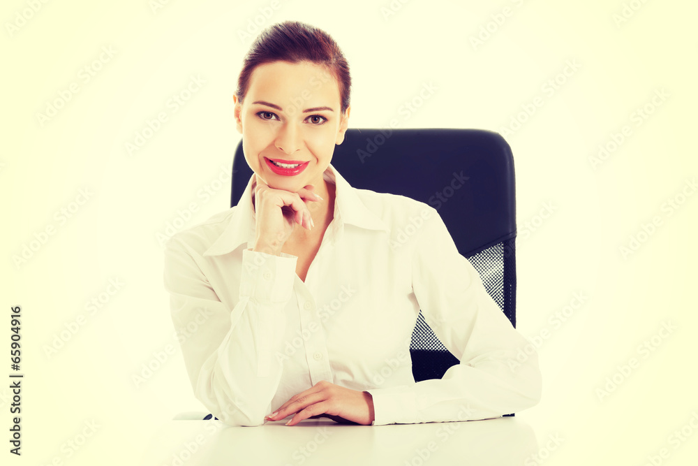 Beautiful business woman, boss sitting on a chair. Beautiful business woman, boss sitting on a chair.