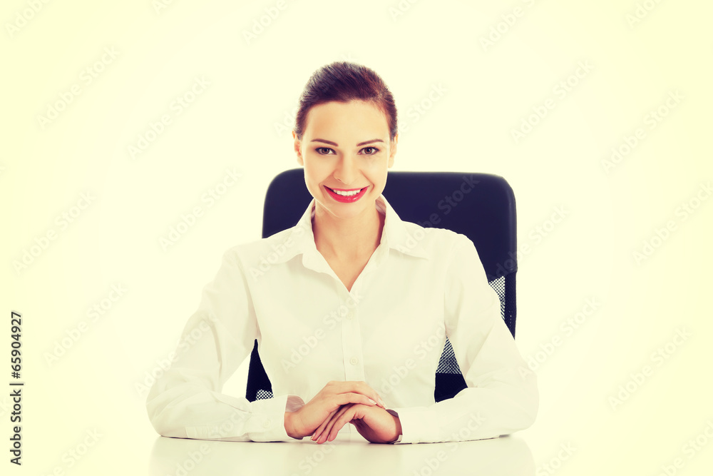 Beautiful business woman, boss sitting on a chair. Beautiful business woman, boss sitting on a chair.