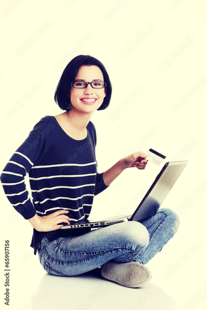 Woman with a laptop and a credit card Woman with a laptop and a credit card