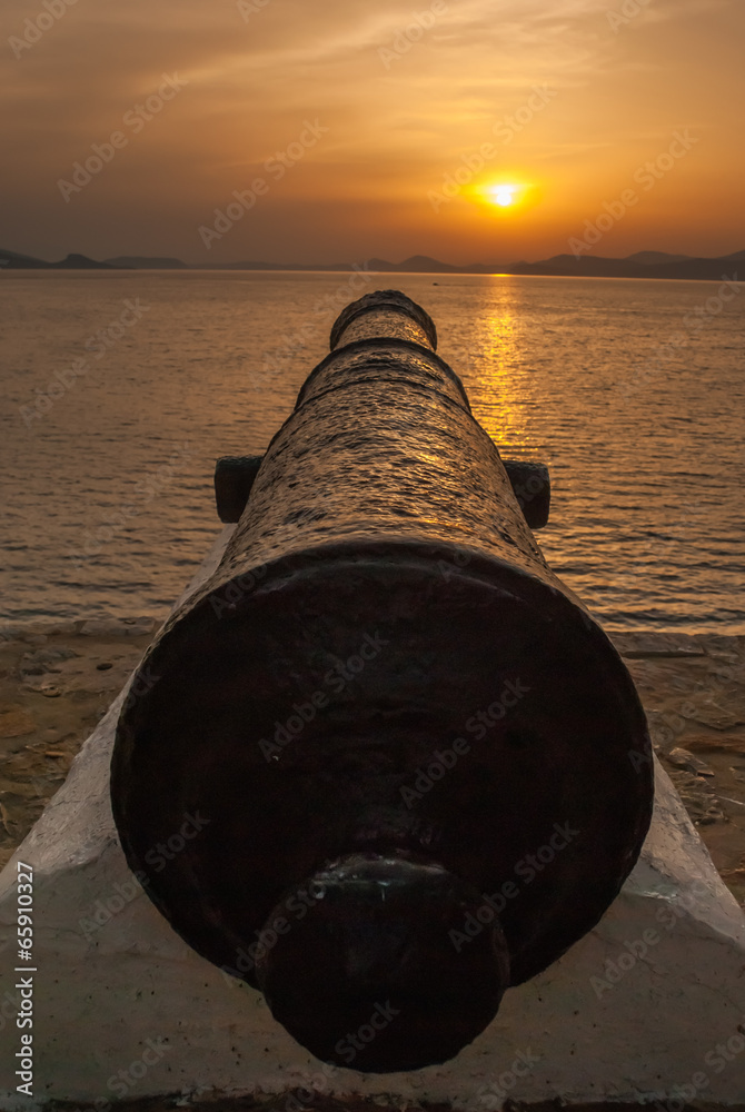 Old cannon at sunset
