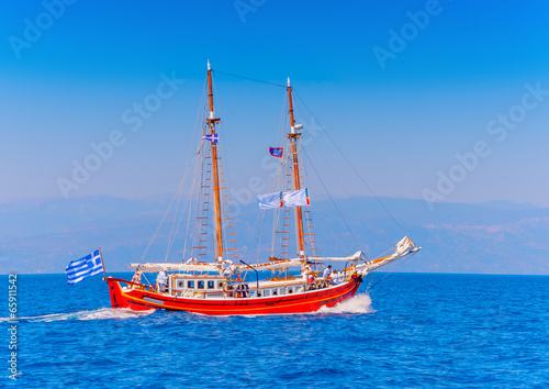 Old wooden red Greek boat (Perama) in Spetses island in Greece