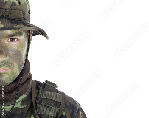 Young soldier with jungle camouflage paint.