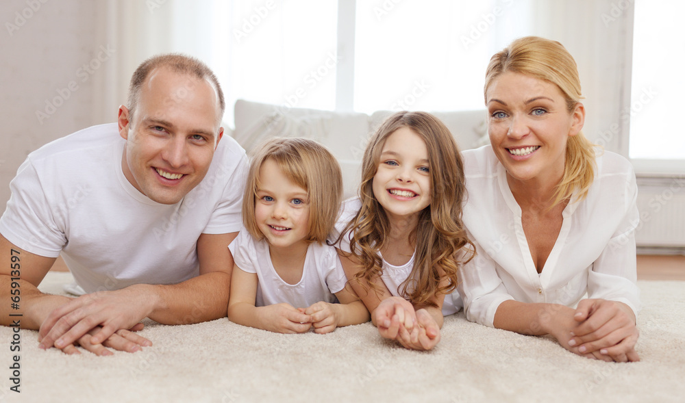 parents and two girls lying on floor at home