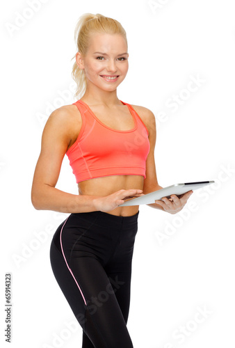 smiling sporty woman with tablet pc computer © Syda Productions