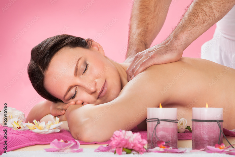 Woman Receiving Back Massaging In Spa Woman Receiving Back Massaging In Spa
