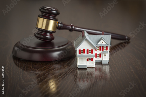 Gavel and Small Model House on Table photo