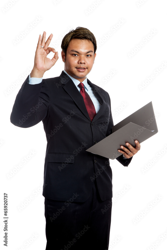 Asian businessman show ok sign with a report Asian businessman show ok sign with a report