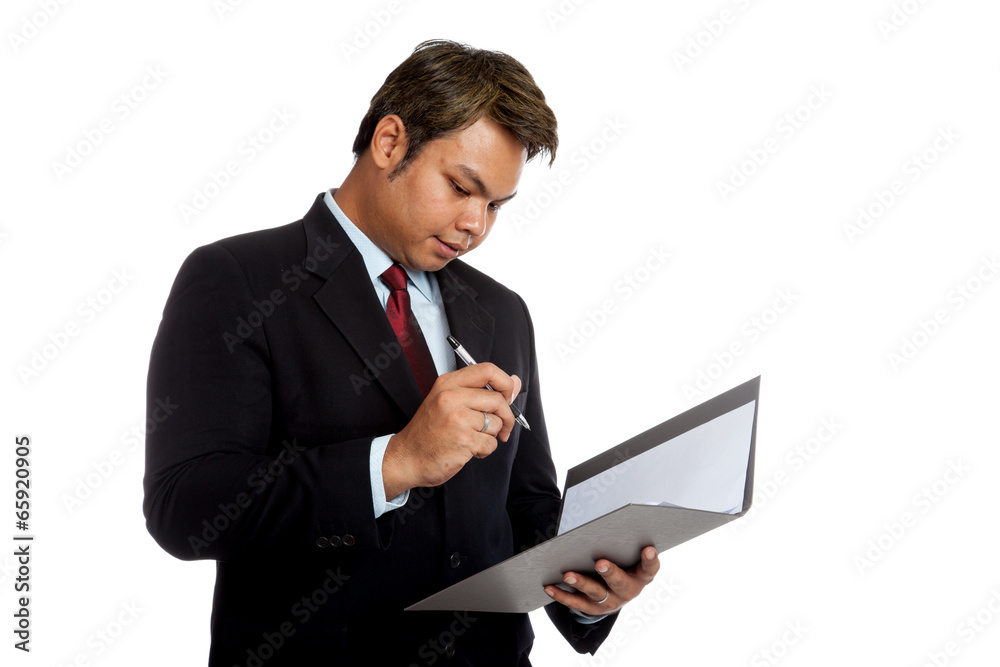 Asian businessman sign signature in a report Asian businessman sign signature in a report