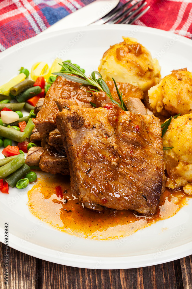 Pork spareribs served with mashed potatoes Pork spareribs served with mashed potatoes