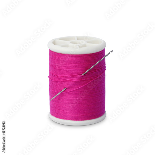 Spool of thread with needle isolated on white