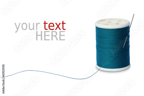 Sewing thread and needle on white