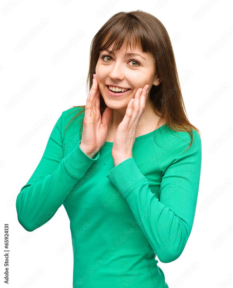 Woman is holding her face in astonishment Woman is holding her face in astonishment