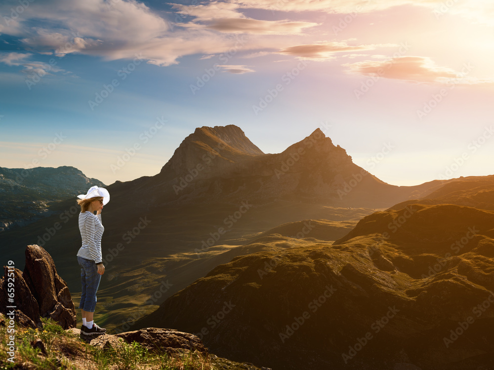Woman standing on the edge of a cliff