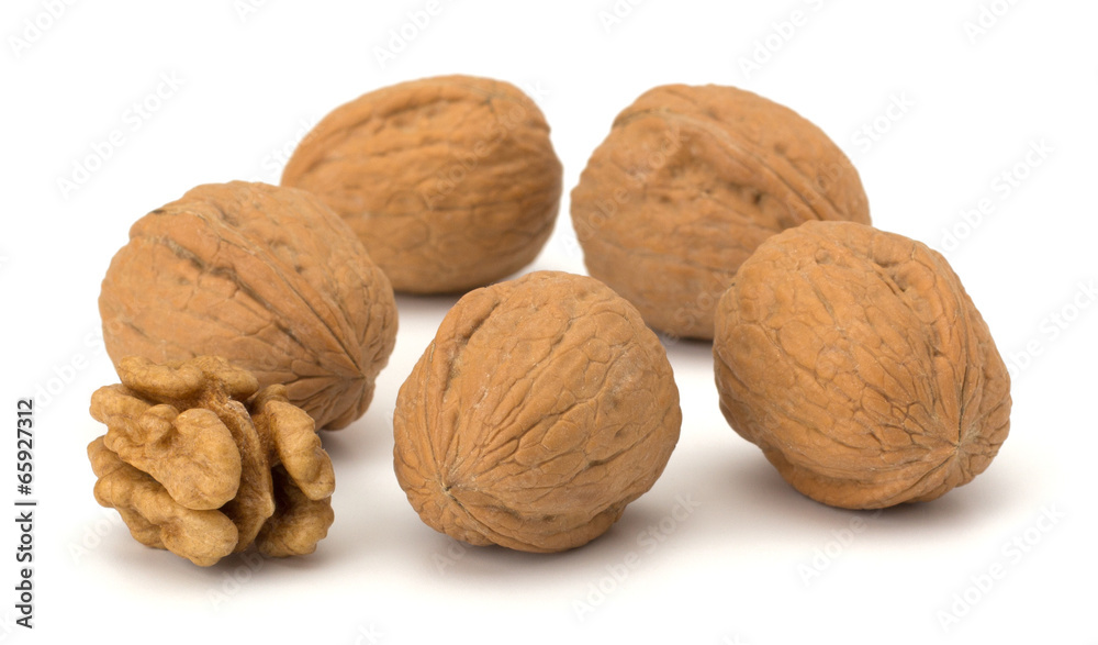 whole and cracked walnut isolated on the white background whole and cracked walnut isolated on the white background