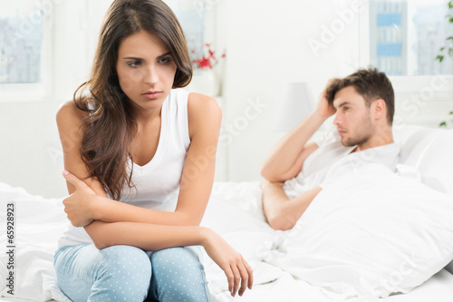 unhappy young couple in bedroom