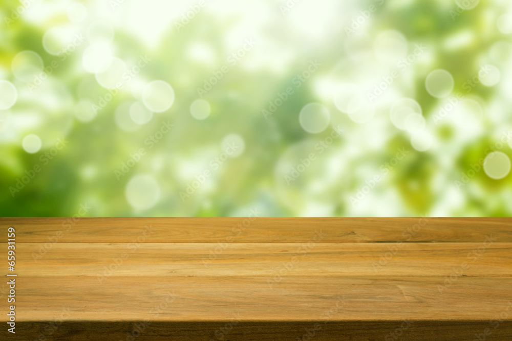 Wooden table over green bokeh background Wooden table over green bokeh background