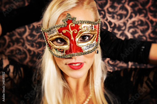 Elegantly dressed light hair model wearing a mask.