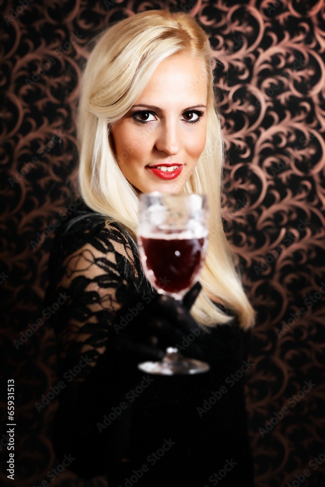 Elegantly dressed light hair model holding a Crystal glass. Elegantly dressed light hair model holding a Crystal glass.
