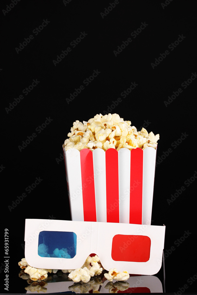 popcorn and glasses isolated on black