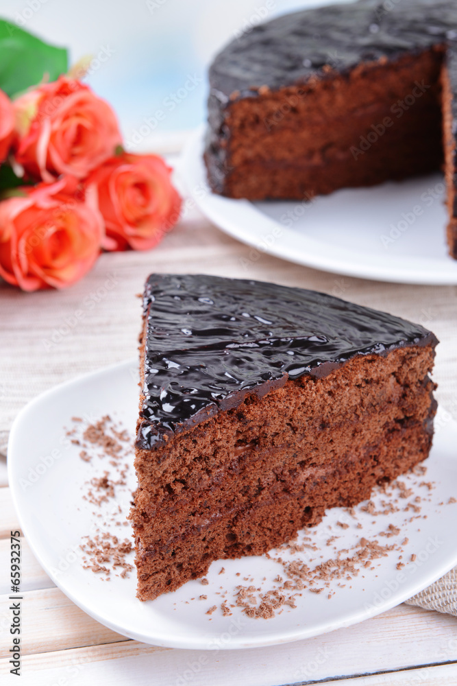 Delicious chocolate cake on plate on table on light background Delicious chocolate cake on plate on table on light background
