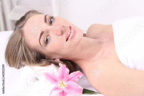 Beautiful young woman having relax in spa salon, close up