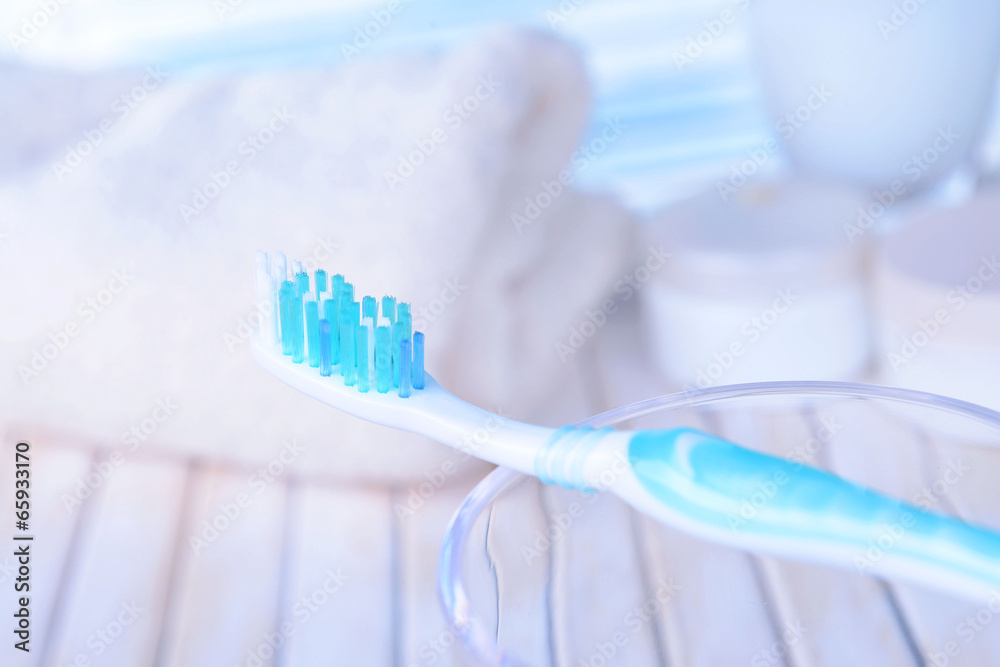 Toothbrush in glass on table on light background Toothbrush in glass on table on light background