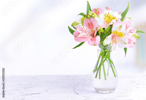 Fototapeta Naklejka Na Ścianę i Meble -  Alstroemeria flowers in vase on table on light background