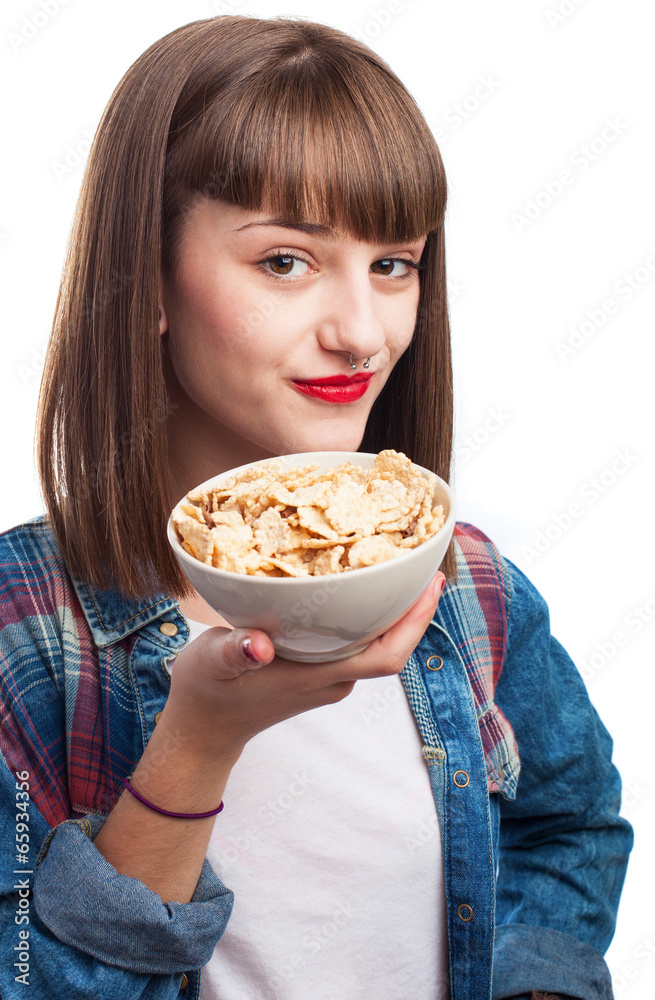 young woman eating cereals isolated on white background young woman eating cereals isolated on white background