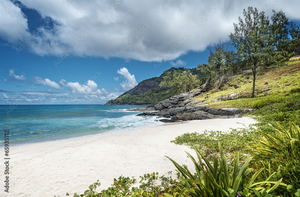Tiny white-sand beach in Seychelles