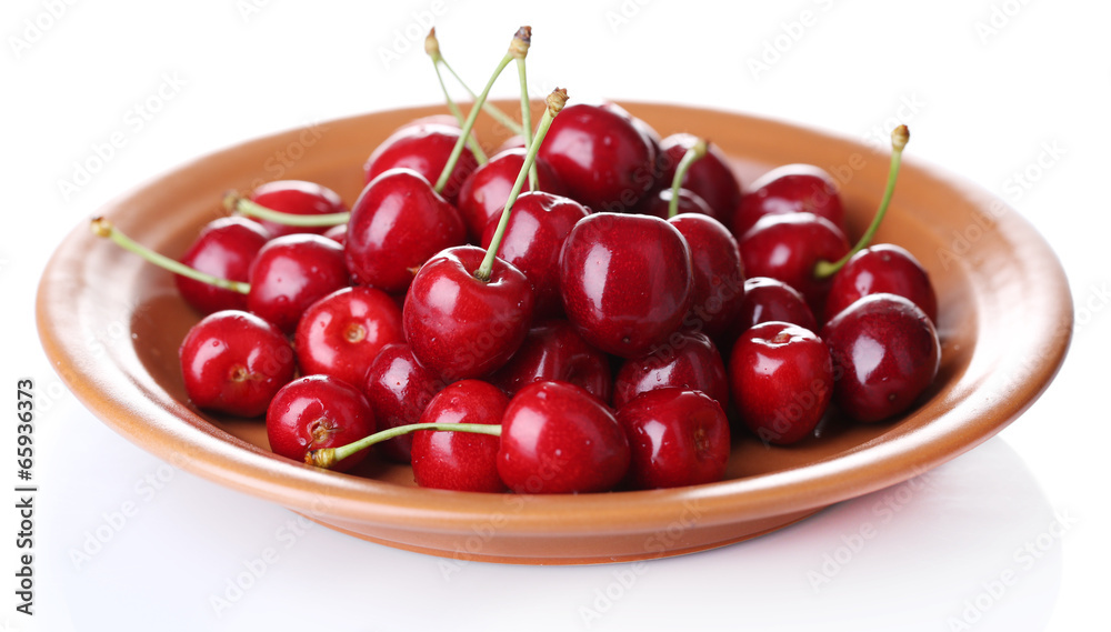 Sweet cherry on color plate isolated on white Sweet cherry on color plate isolated on white