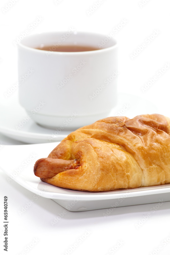 Classical breakfast a croissant sausage and cheese