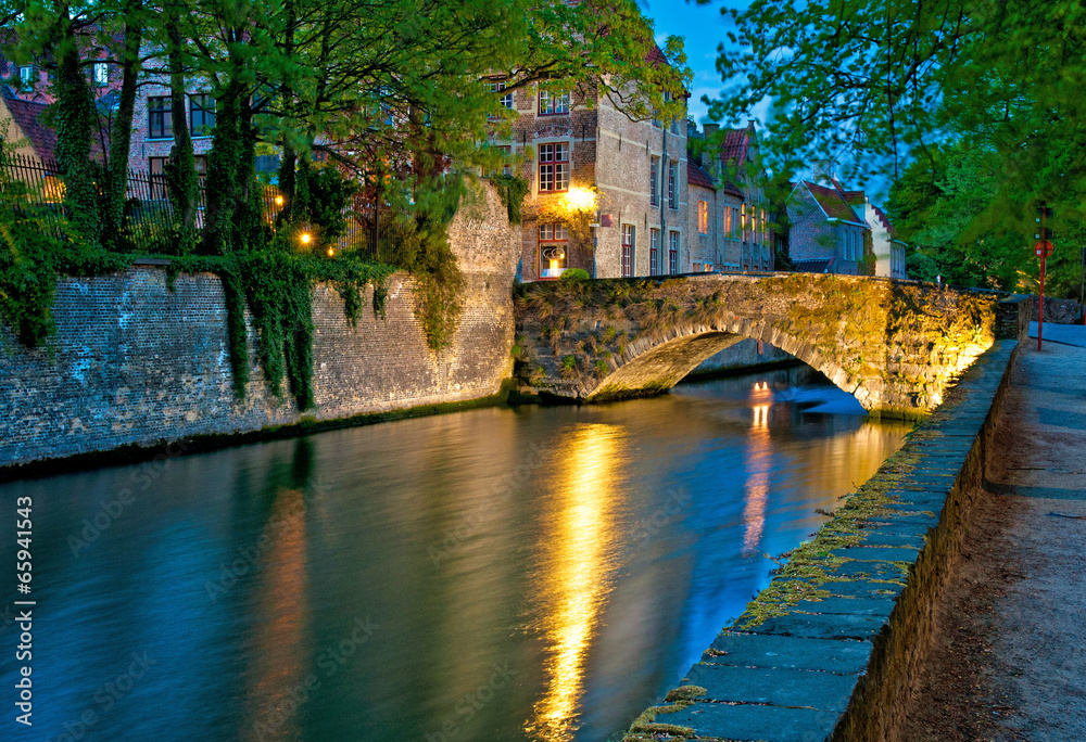 Naklejka premium Historic medieval buildings along a canal in Bruges, Belgium